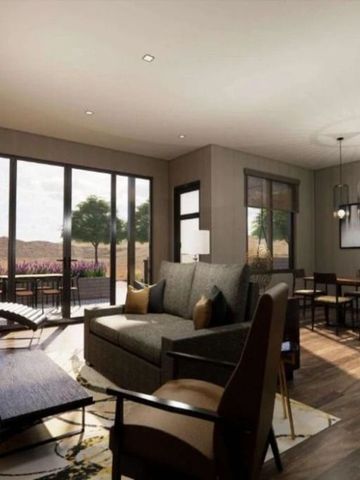 Helles Wohnzimmer in einer Suite mit großen Fensterfronten und moderner Einrichtung