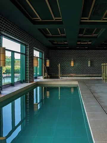 Eleganter Innenpool mit modernen Design-Elementen und großen Fenstern