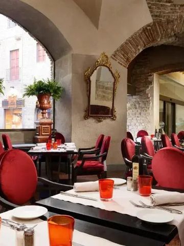 Elegantes Restaurant mit roten Stühlen und gedeckten Tischen im Brunelleschi Hotel