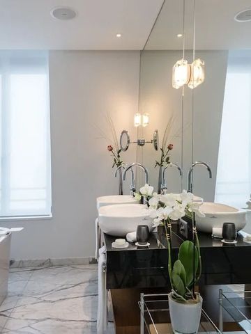 Modernes Badezimmer mit Doppelwaschbecken und eleganten Pflanzen im Bürgenstock Hotel