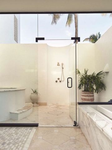 Geräumiges Badezimmer mit offener Dusche und Pflanzen im Freien