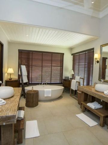 Geräumiges Badezimmer mit rustikalen Holzmöbeln und Badewanne