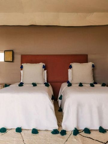 Zeltzimmer mit zwei Einzelbetten und stilvollen Laternen im Caravan Agafay