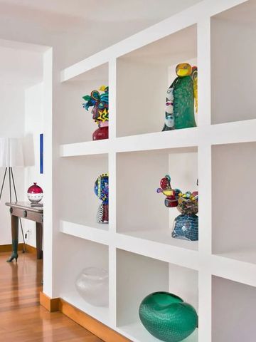 Helle Hotellobby mit moderner Kunst in weißen Regalen