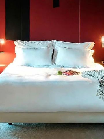 Komfortables Doppelbett mit dekorativen Kissen im stilvollen Raum