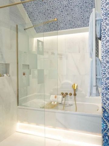 Modernes Badezimmer mit Glasdusche und blauer Mosaikfliese