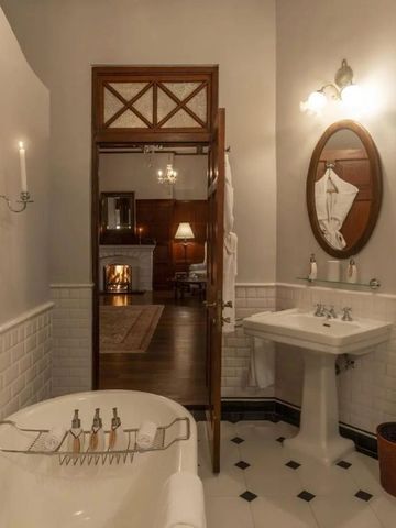 Charmantes Badezimmer mit Blick auf elegantes Wohnzimmer mit Kamin