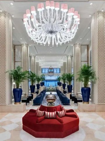 Luxuriöse Lobby des Ciragan Palace Kempinski mit großem Kronleuchter und blauen Vasen