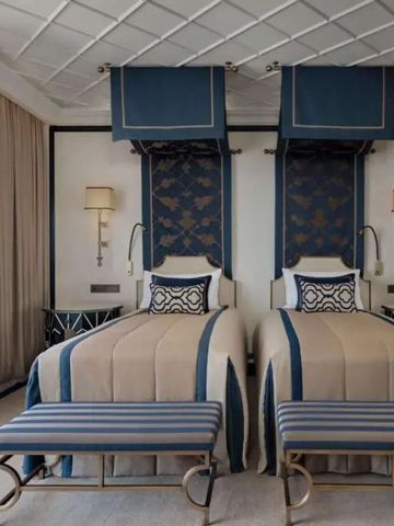 Doppelzimmer mit zwei Betten und stilvollem blauen Dekor