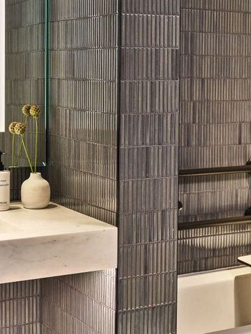 Elegantes Hotelbad mit stilvoller Fliesenwand und moderner Ausstattung