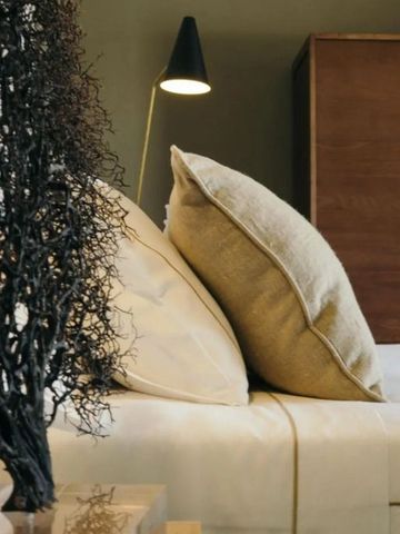 Nahaufnahme von Kissen auf einem Bett mit stimmungsvoller Beleuchtung