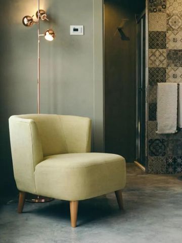 Komfortabler Sessel neben stilvoller Badezimmergestaltung