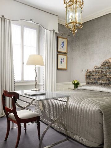 Luxuriös gestaltetes Schlafzimmer mit opulentem Bett und Arbeitsbereich im Hotel d'Angleterre