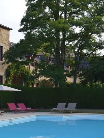 Außenpool umgeben von historischen Gebäuden und grünen Bäumen