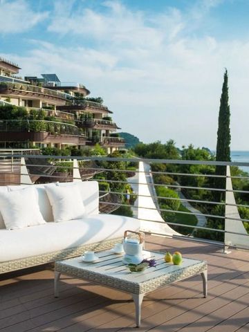 Terrasse mit weißem Sofa und Teeservice bietet Blick auf das Meer und moderne Architektur
