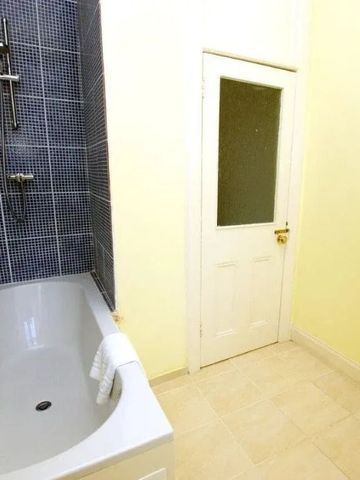 Modernes Badezimmer mit Badewanne und stilvollen Fliesen.