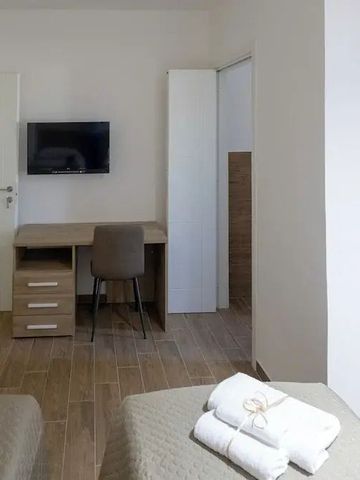 Zimmeransicht mit Schreibtisch, Stuhl und Flachbildfernseher