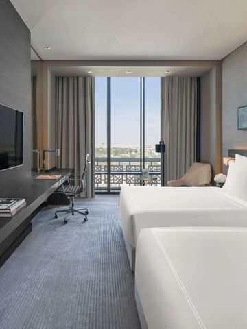 Geräumiges Zimmer mit zwei Betten und großem Fenster mit Aussicht