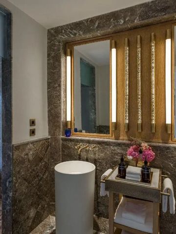 Modernes Badezimmer mit Marmorakzenten und eleganter Beleuchtung.