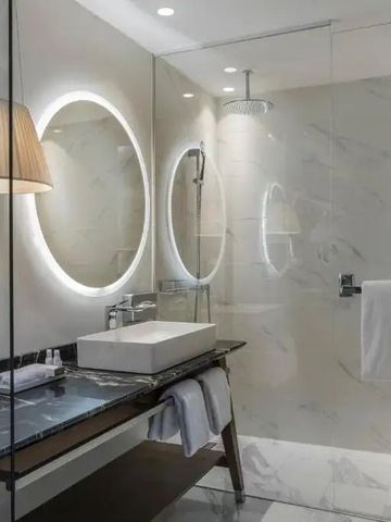 Luxuriöses Badezimmer mit modernem Waschbecken und geräumiger Dusche