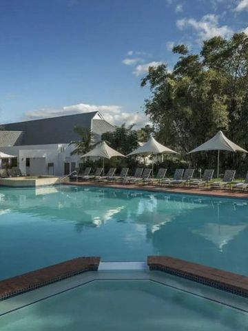 Geräumiger Außenpool mit Liegestühlen und Sonnenschirmen