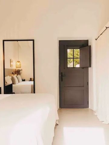 Lichtdurchflutetes Zimmer mit Spiegel und Holztür bei Finca Serena Mallorca