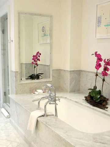 Luxuriöses Badezimmer mit Marmorelementen und Badewanne