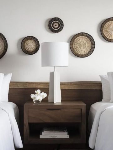 Zwei Einzelbetten mit stilvollen Wanddekorationen und eleganten Details.