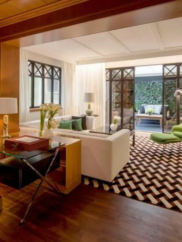 Gemütliches Wohnzimmer mit modernem Design, Grünpflanzen und Terrasse im Hintergrund