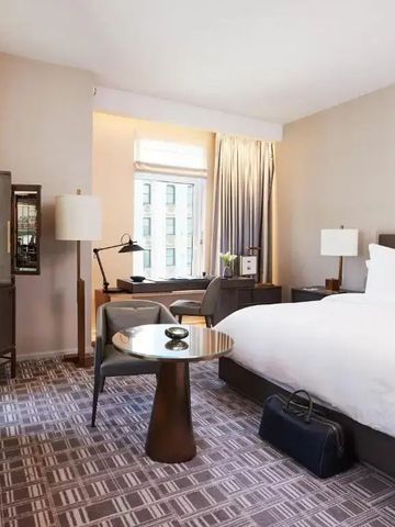 Geräumiges Hotelzimmer mit Doppelbett und Sitzbereich