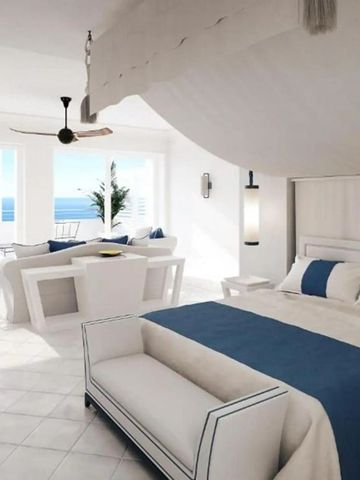 Luxuriöses Zimmer mit Doppelbett und Meerblick in Blau-Weiß-Tönen