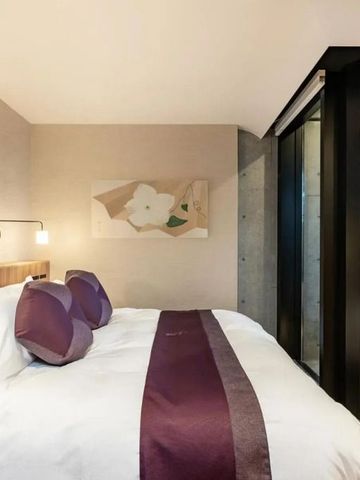 Stilvolles Zimmer mit großen Fenstern und Blick auf die Dächer von Kyoto