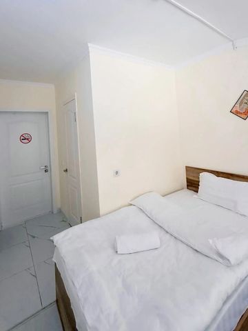 Helles Einzelzimmer mit Bett und minimalistischer Dekoration