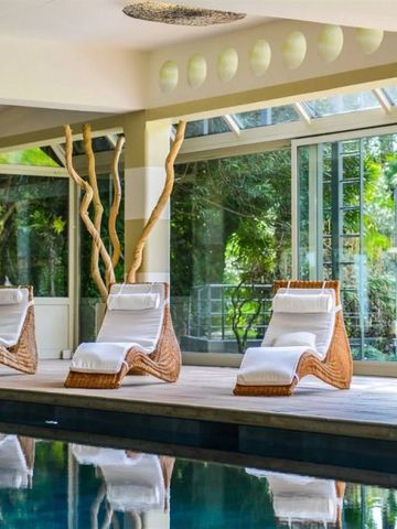 Elegante Liegen am Indoor-Pool mit Blick auf die grüne Umgebung