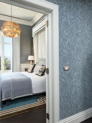 Elegantes Schlafzimmer in Blau- und Grautönen mit stilvoller Dekoration.