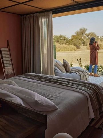 Zimmer mit offenem Zugang zur Terrasse und Blick auf die Natur