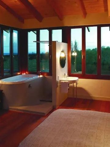 Romantisches Zimmer mit freistehender Badewanne und Fenstern mit Aussicht