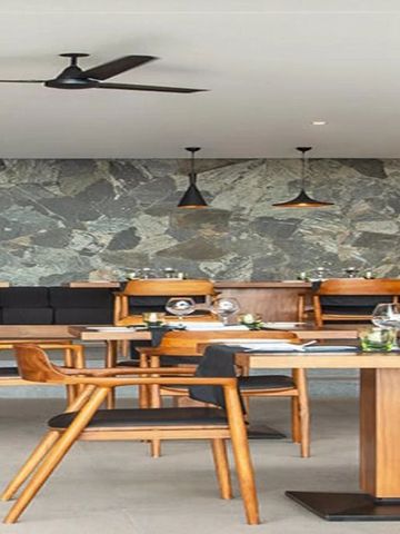 Stilvolles Hotelrestaurant mit Holzmöbeln und Steinwand