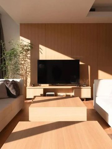 Heller Lounge-Bereich mit großem Fernseher und eleganten Sofas