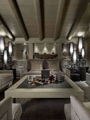 Elegante Lounge im alpinen Stil mit Kamin und stilvoller Beleuchtung