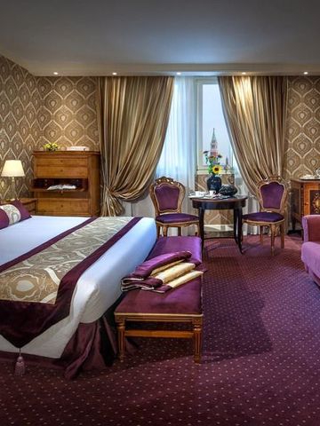 Geräumiges Hotelzimmer mit warmen Farben und eleganter Einrichtung