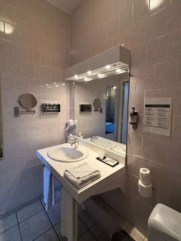 Waschtisch im Badezimmer mit großem Spiegel und Beleuchtung