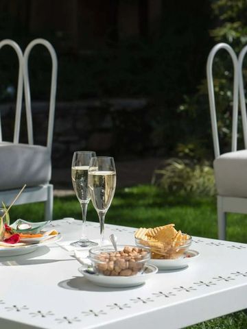 Gartenlounge mit Tischgedeck und Champagnergläsern
