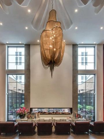 Elegante Lobby mit beeindruckendem Kronleuchter und roten Vorhängen.