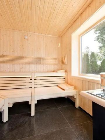 Sauna mit hölzernem Interieur und großem Fenster