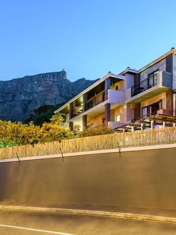 Moderne Hotelarchitektur vor Bergpanorama bei Sonnenuntergang.