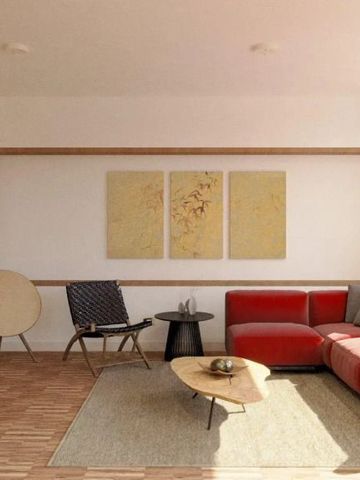 Wohnbereich mit rotem Sofa und minimalistischer Dekoration