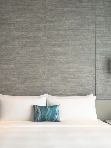 Komfortables Doppelbett im stilvollen Zimmerdesign mit Akzentkissen.