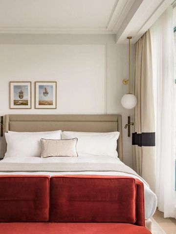 Elegantes Hotelzimmer mit großen Fenstern und gemütlichem Doppelbett