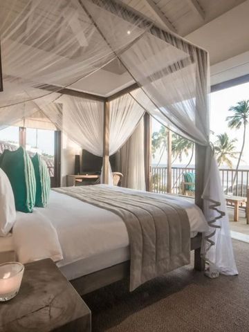 Himmelbett in Zimmer mit Meerblick und dekorativer Veranda